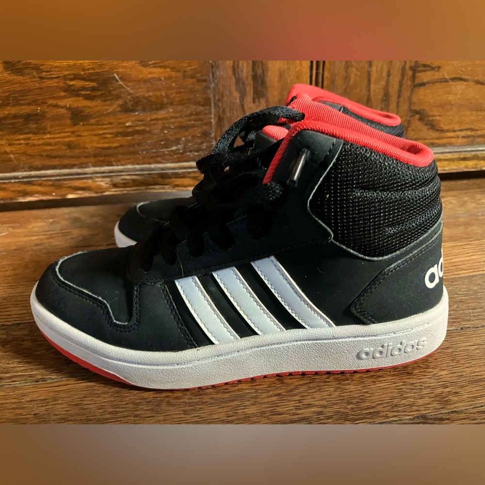 Adidas kids basketball shoes in black and white. Barely used in size 4.